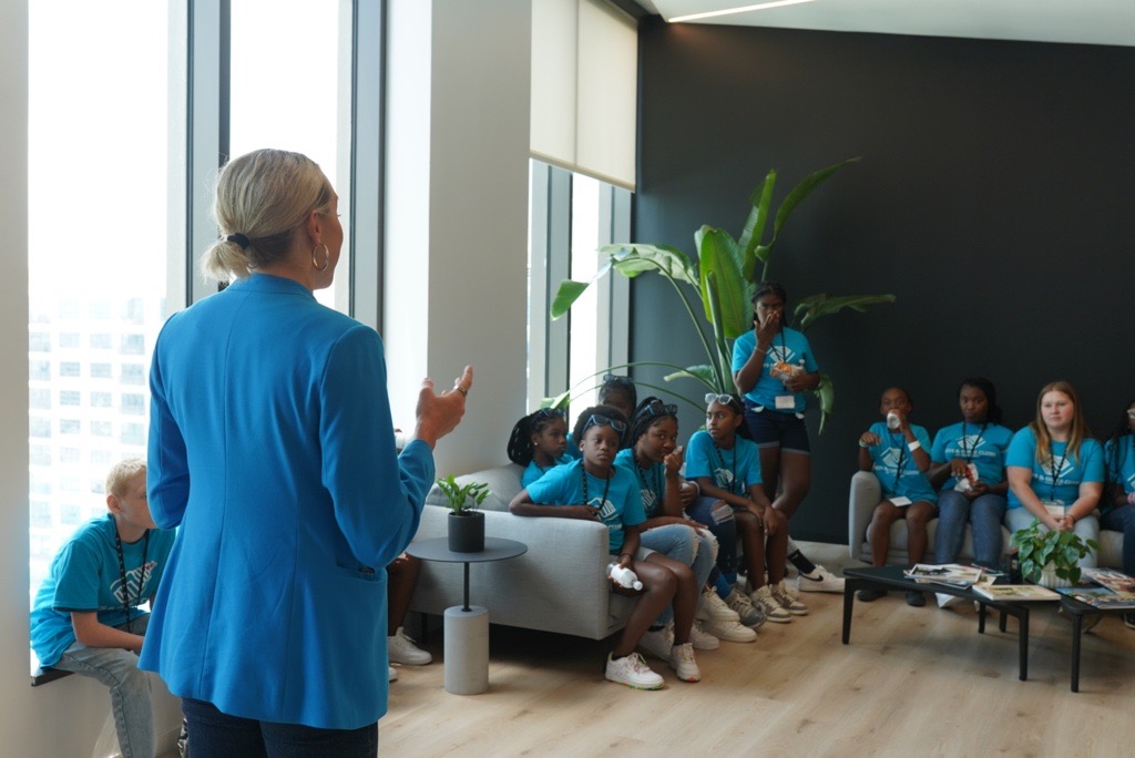 A ReliaQuest employee teaches a group of kids about cybersecurity at the ReliaQuest offices in Tampa, Florida.